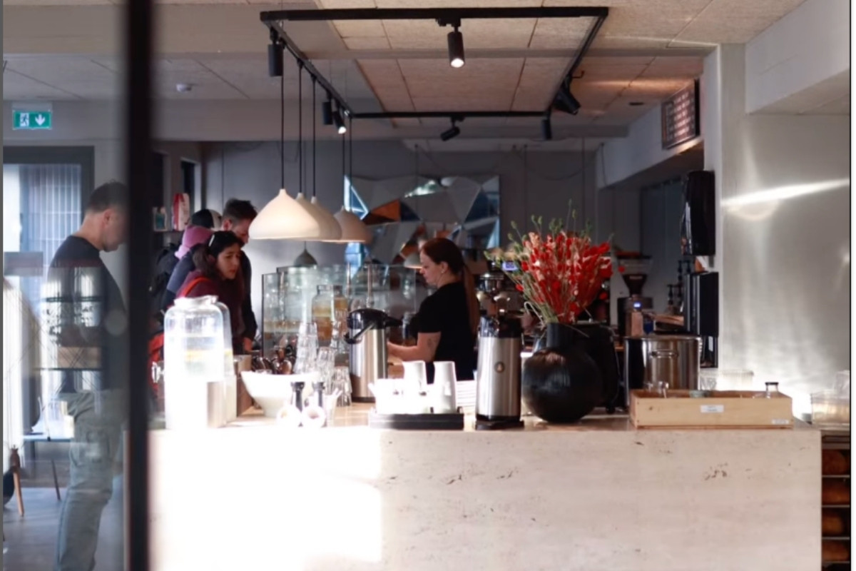 The counter area inside Hygge Coffee and Micro Bakery in Reykjavik, with staff serving customers and a view of the bakery items.