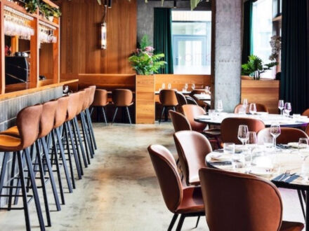 Interior view of OTO Restaurant in Reykjavik, Iceland, showing the bar area and dining tables.