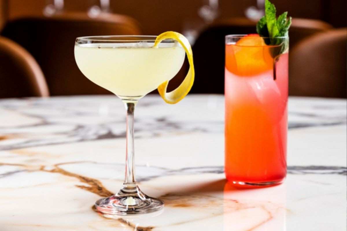 wo beautifully crafted cocktails on a marble table at OTO Restaurant in Reykjavik.