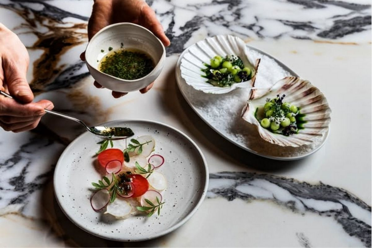 Elegant seafood appetizer being prepared and served at OTO Restaurant, Reykjavik, Iceland.