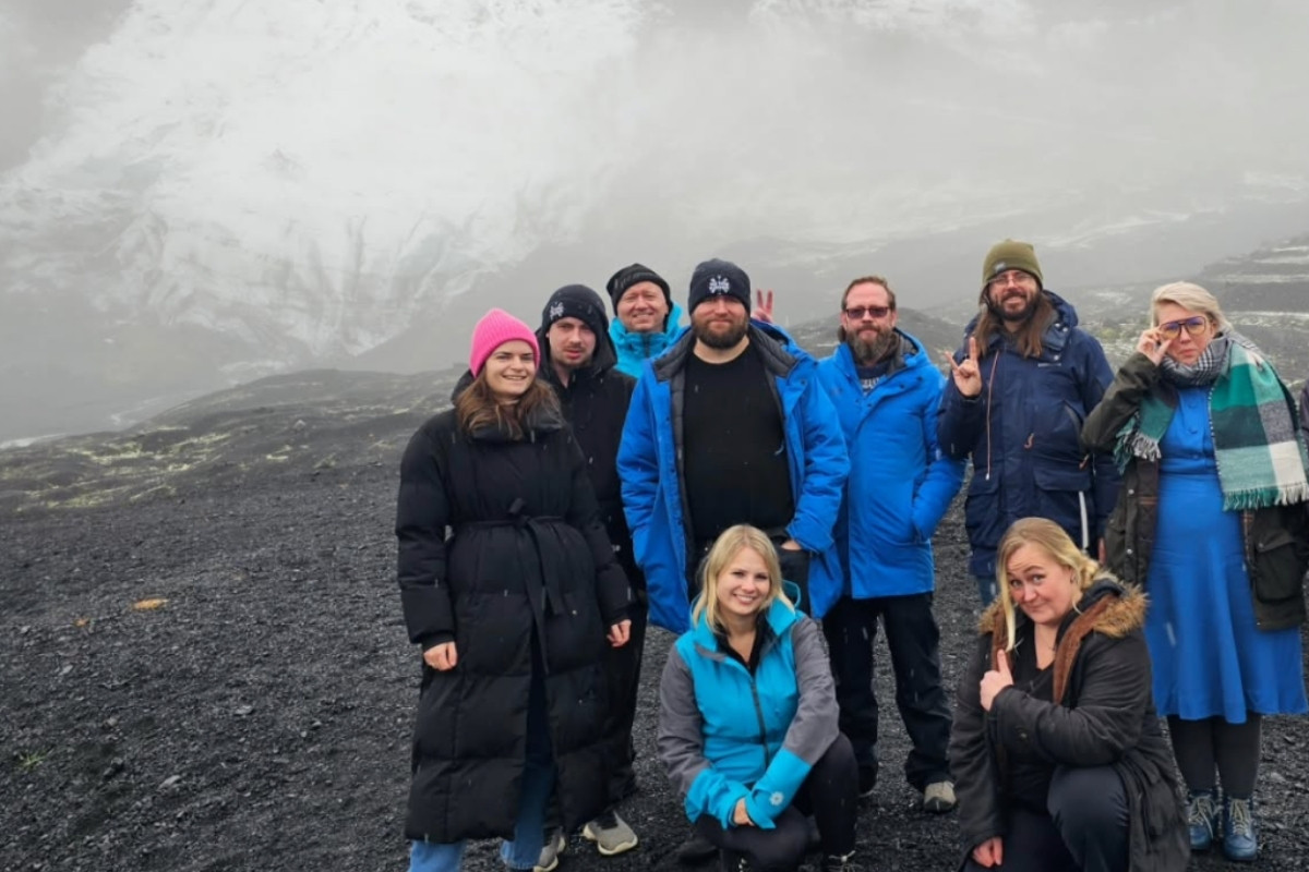A group of people, likely on a tour with 