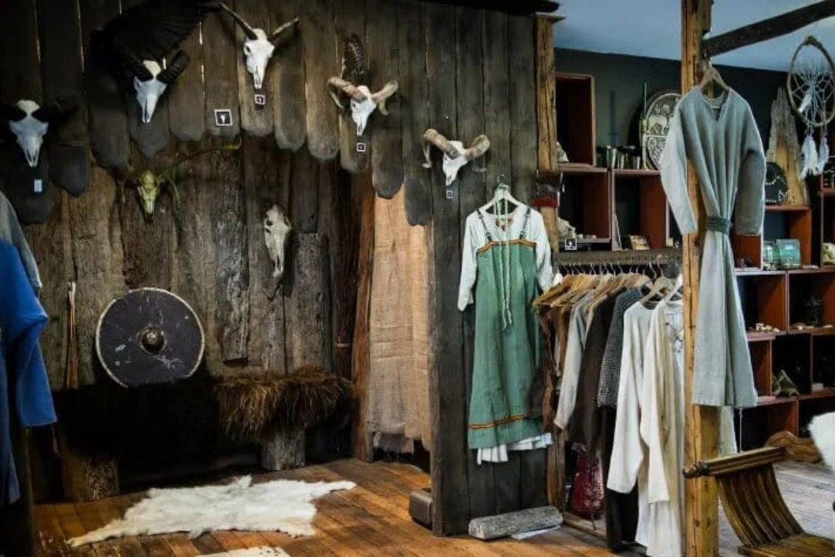 An interior view of Mink Viking Portrait in Reykjavik, showcasing historical-style clothing, animal skulls, shields, and other Viking-themed artifacts.