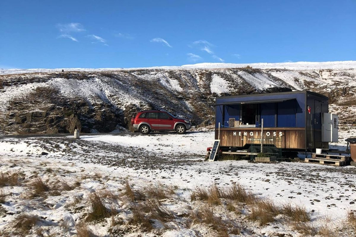 Hengifoss food truck in snowy landscape.
