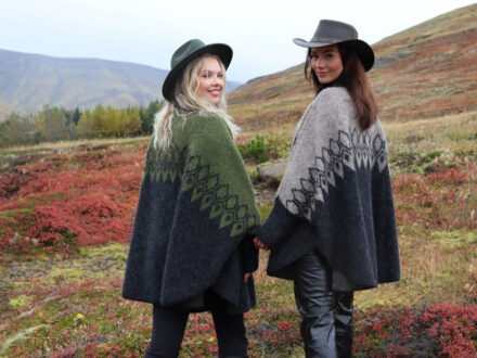 Models showcasing Kidka Knitwear collections, one green and one grey, in a scenic landscape.