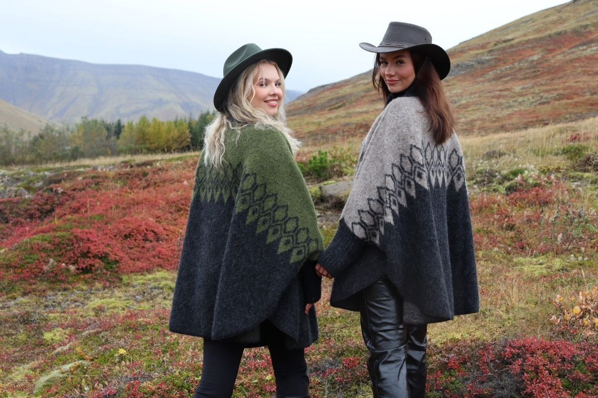 Models showcasing Kidka Knitwear collections, one green and one grey, in a scenic landscape.
